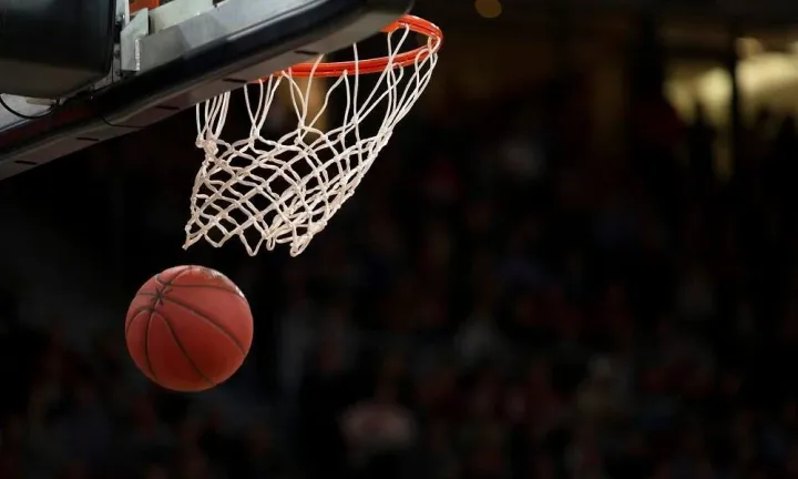 Basketball about to drop through hoop during NBA preseason opener on October 2, 2025, highlighting start of new season and key storylines.